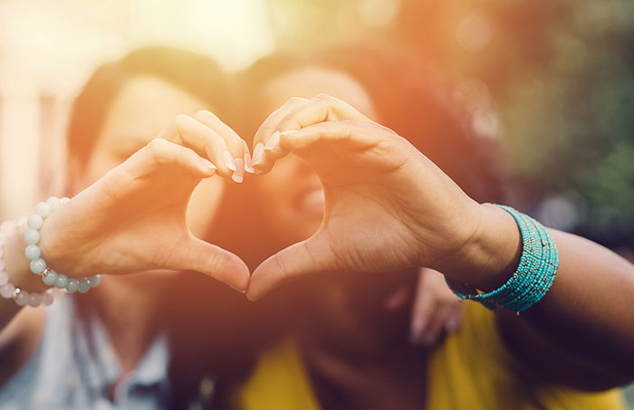 Couple making heart with hands